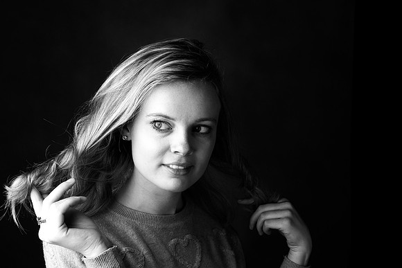 black and white photo of woman in studio