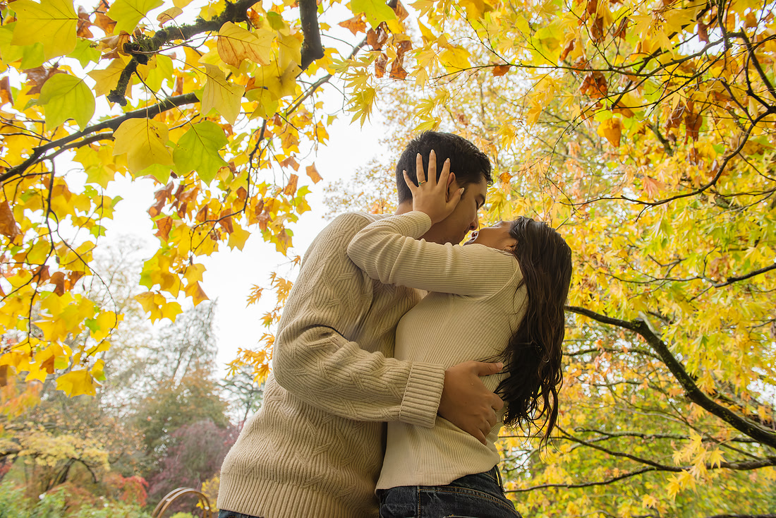 Couple looking at each other on their engagement day at the Botanical Gardens in Bath