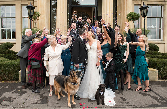 Bride, groom and wedding guests with dogs outside Macdonald Bath Spa Hotel