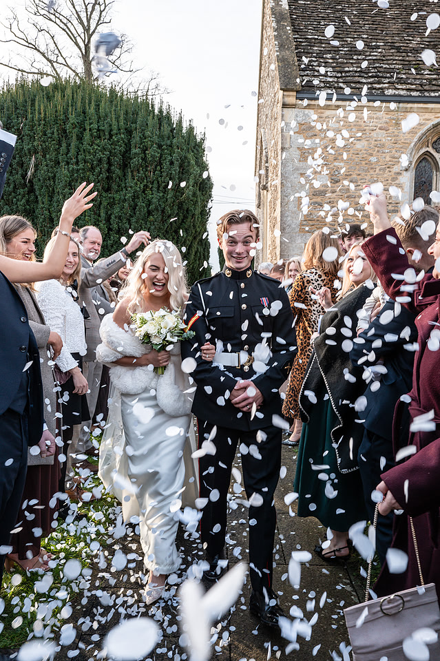 Relaxed, documentry style picture of confetti shot of a newly wed couple outside a church. Picture captured by Bath Photographer
