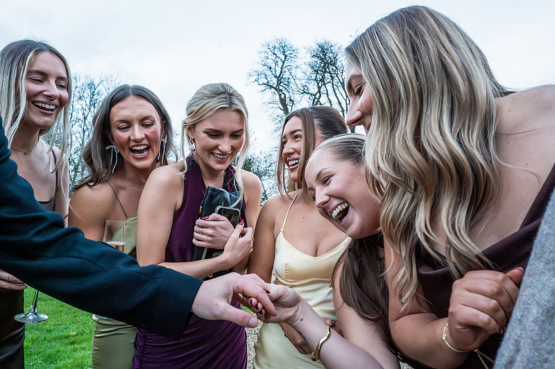 Picture is showing friends of the bride admiring groom ring. The photo shows adimiration, happiness. Picture taken by Bath based photographer who loves capturing documentry style pictures.