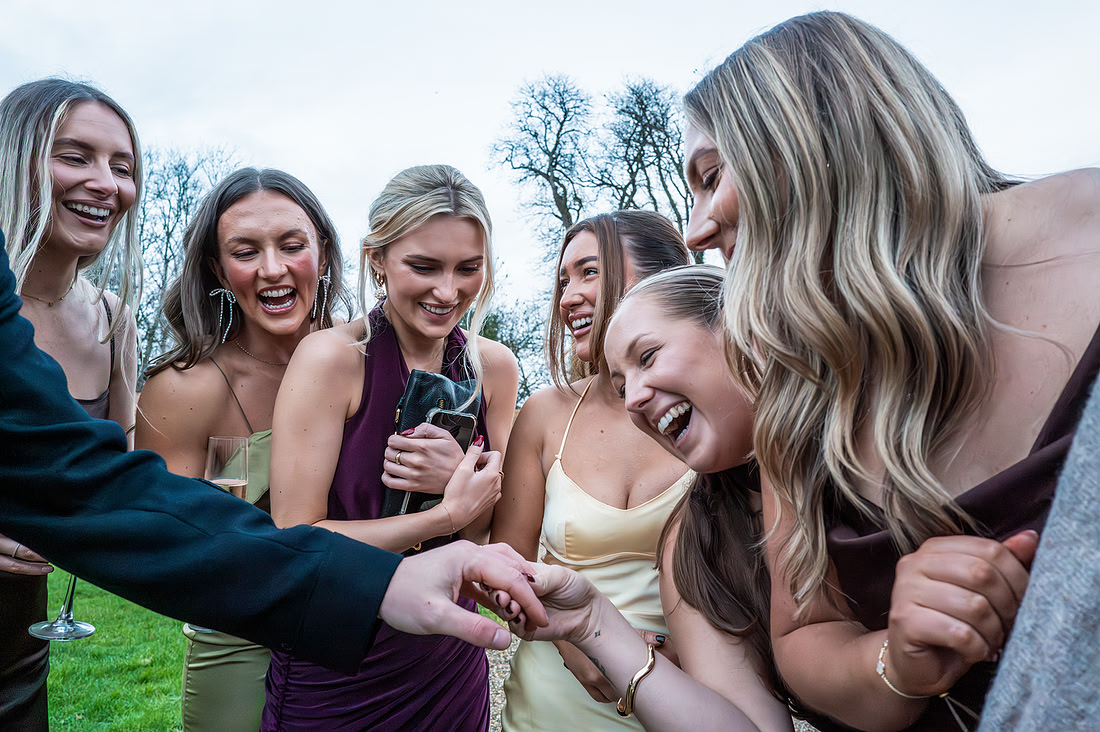 Picture is showing friends of the bride admiring groom ring. The photo shows adimiration, happiness. Picture taken by Bath based photographer who loves capturing documentry style pictures.