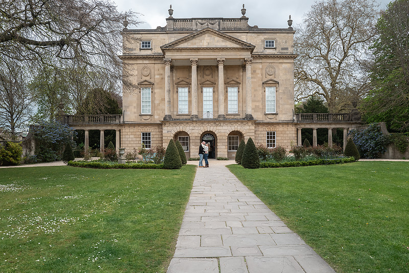 Bridgerton style. Bath surprise proposal captured by local photographer Beata Cosgrove Photography. Couple standing in front of the museum on their engagement day