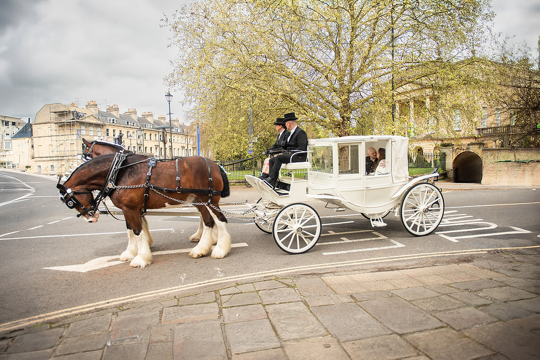 Bridgerton style Bath surprise proposal captured by Beata (Bea). Photos shows the couple in the carriage on their engagement day in Bath.